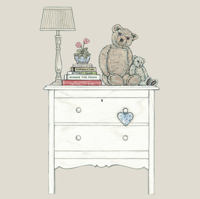 2 bears sat next to a pile of bear books on a chest of drawers