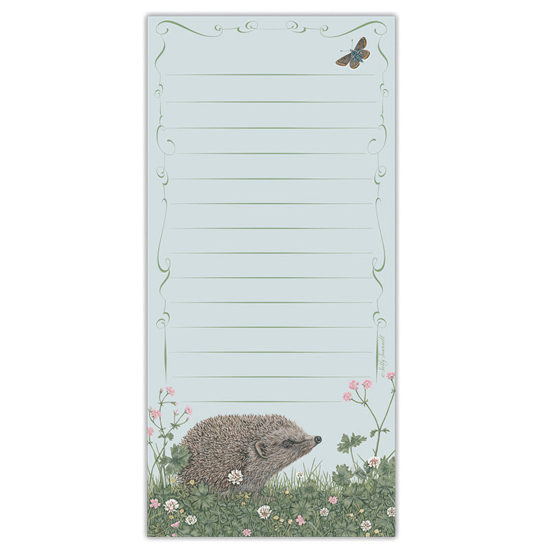 A jotter pad with an illustration of a hedgehog amongst cranesbill and white clover flowers, a butterfly in the top right. Page is lined with an ornate border design.