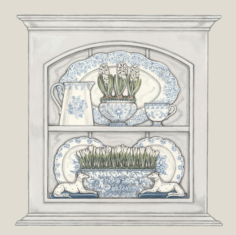 A greetings card featuring a little cupboard filled with blue and white china. A jug, a cup, plates, hyacinth bowl, crocus bowl and 2 china dogs