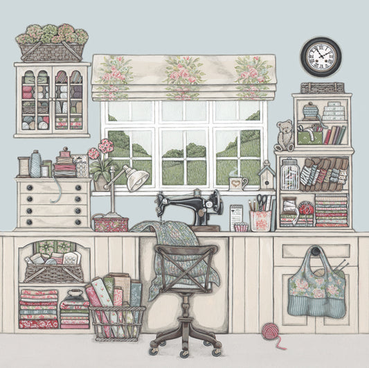 A  greetings card featuring a sewing or craft room containing cupboards and shelves filled with fabric, ribbon, thread, bobbins, sewing boxes, wool, scissors. There is a  singer sewing machine  on the desk and fabrics underneath.