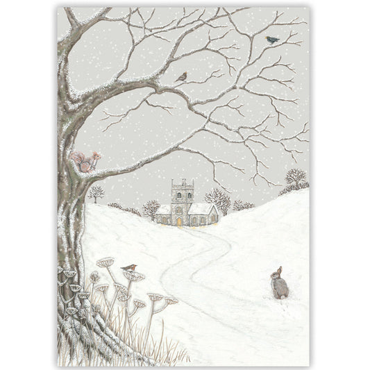 A winter landscape Christmas card featuring a snow-covered hill with a small church in the distance, bare tree branches overhead, birds, a red squirrel, and a rabbit in the foreground.