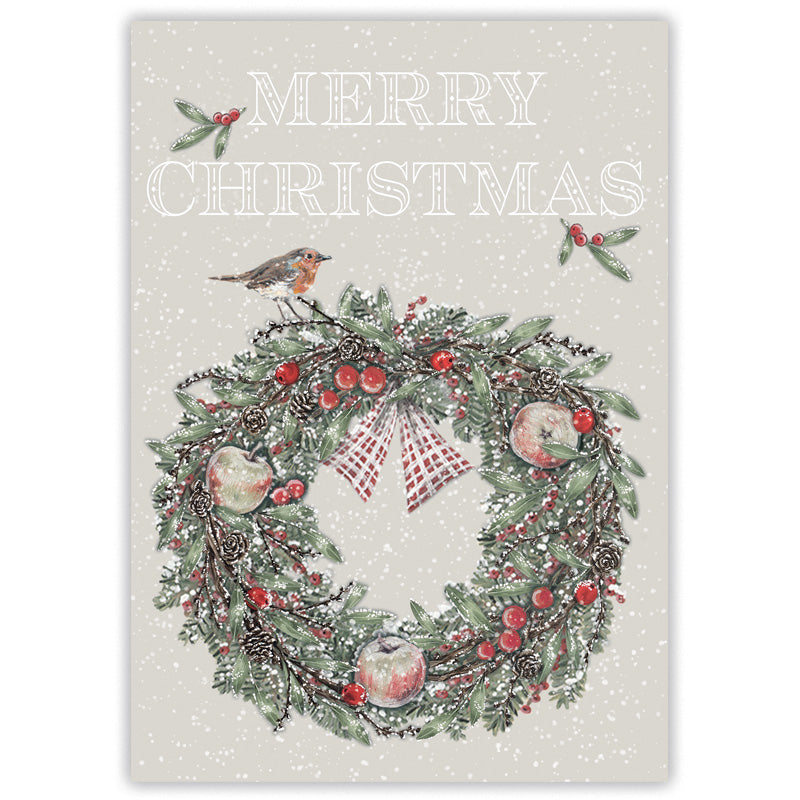 A Christmas greeting card with a snowy off-white background, featuring the words “MERRY CHRISTMAS” above a decorated wreath with red berries, pinecones, ornaments, holly leaves, and a robin perched on top.