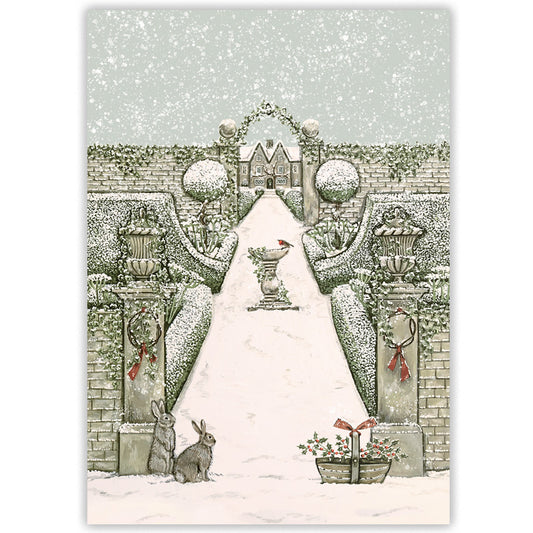 A winter garden illustrated Christmas card with a snow-covered path leading through an archway to a distant house, with hedges, urns, rabbits, and falling snow. 