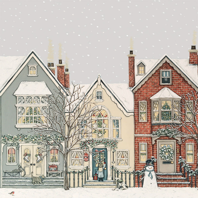 A festive winter street scene with three illustrated houses covered in snow, decorated with wreaths and lights, a snowman standing in front of the brick house, bare trees, and falling snow in the background.