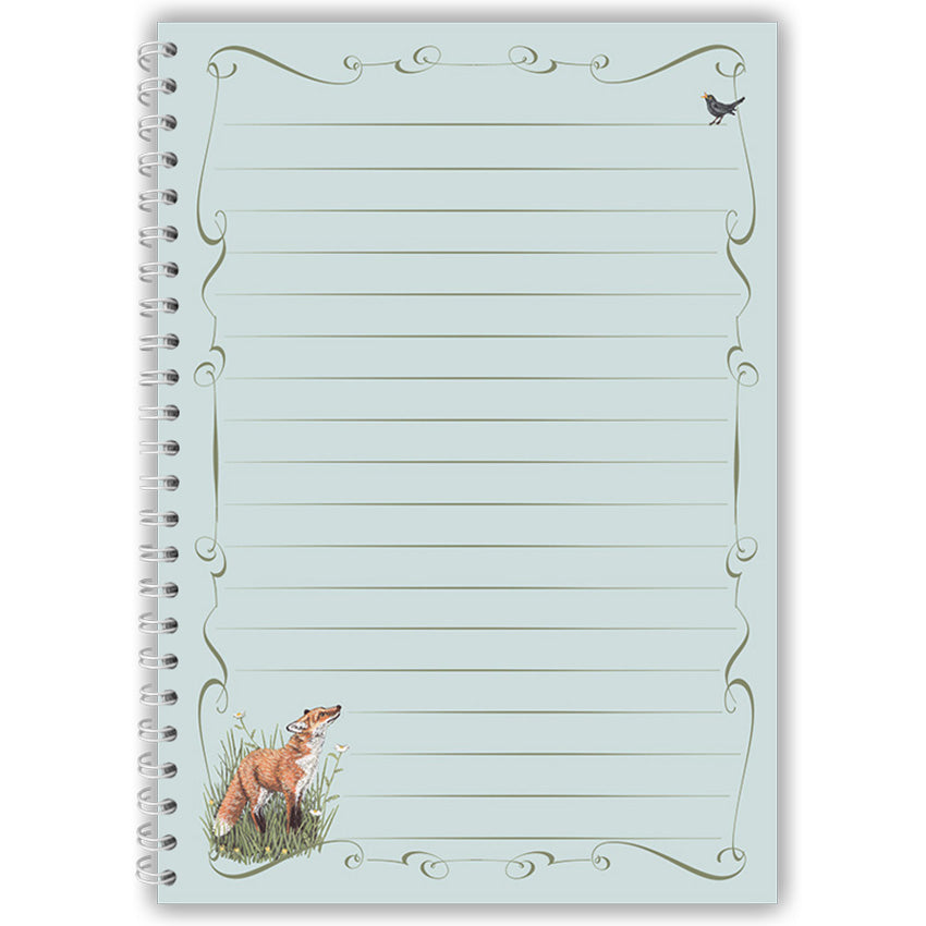 Notebook with fox and blackbird illustration on a light blue background