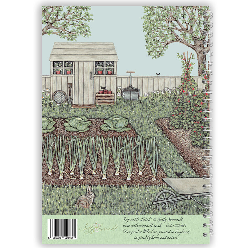 Garden scene with a shed, plants, and a rabbit on a notebook cover.