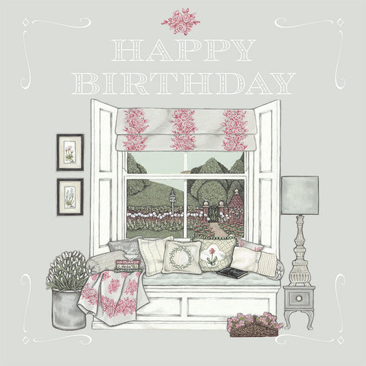 A pretty illustrated birthday card depicting a window seat decorated with cushions and books, overlooking a beautiful walled garden.